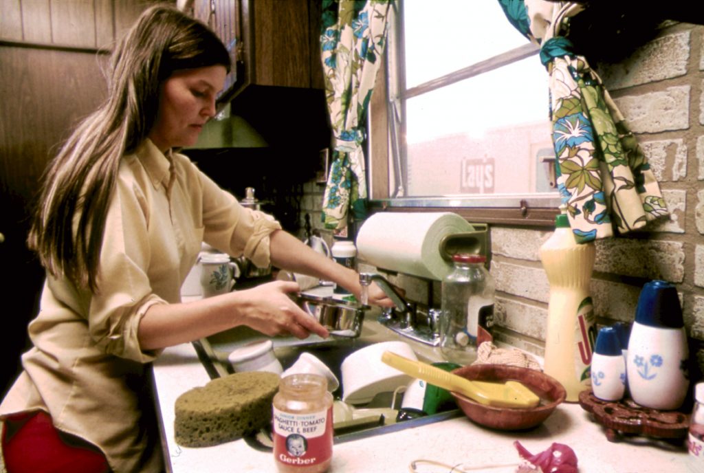 HOUSEWIFE IN THE KITCHEN OF HER MOBILE HOME IN ONE OF THE TRAILER PARKS. THE TWO PARKS WERE CREATED IN RESPONSE TO... NARA 558298